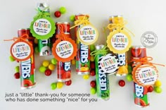 candy bar wrappers with name tags and candies tied to the top, on a white background