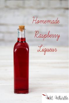 a bottle of raspberry liqueur sitting on a table with the words homemade raspberry liqueur