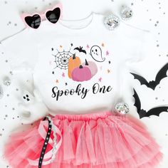 Pink Pumpkin Spooky One Halloween Birthday Shirts Infant Toddler 1st First October Birthday Ghoul Ghost Spooktacular Booday Boo Day Girl Tee To order MULTIPLE SHIRTS, add to cart ONE at a time. Celebrate your little one's Pumpkin 1st birthday cute pink first birthday Halloween with our spooktacular collection of Halloween birthday outfits and shirts! From the adorable first boo day baby girl birthday outfit to the spooky one birthday shirt, we have the perfect look for your little ghoul. Our Halloween 1st birthday shirt, cute pumpkin designs, and ghost birthday tees are ideal for your halloween party or kids halloween birthday party. Family matching is made easy with our spooky halloween family matching birthday shirt and mommy and me birthday ghoul sets. Parents can join the fun too with Boo Bash First Birthday, Boo I’m Two Birthday Girl, One Spooky Babe Birthday, Spooky One First Birthday Outfit, Spooky One First Birthday Girl Outfit, Baby Girl Birthday Outfit, Fall 1st Birthdays, Matching Birthday Shirts, Toddler Girl Halloween