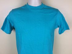 Vintage 80s Hanes plain turquoise t-shirt.  Soft 100% cotton, made in USA.Excellent condition, like never worn.  No holes, no stains, no issues.Size S, but fits slightly smaller than today’s S.  Please note measurements to avoid returns: laid flat measures 17” across chest (armpit to armpit), 26.5” length (top of center of collar on back to bottom of shirt). Turquoise Crew Neck T-shirt For Summer, Casual Turquoise Crew Neck T-shirt, Turquoise Cotton Crew Neck T-shirt, Turquoise Cotton Short Sleeve T-shirt, Plain White T's, Kenny Loggins, Concert Tshirts, Great T Shirts, 1980s Vintage