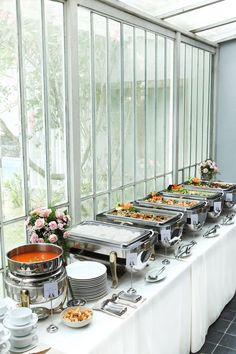 the buffet table is set up with many different foods