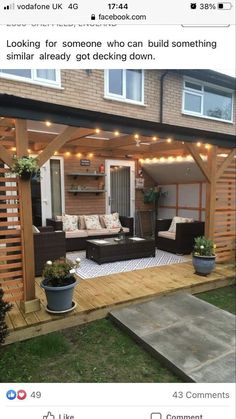 an outdoor living area with couches and lights on the roof, in front of a house