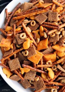 a white bowl filled with cheetos and peanuts on top of a black table