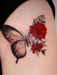 a tattoo with roses and a butterfly on the back of a woman's shoulder