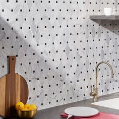 a kitchen counter top with plates and bowls on it next to a wall mounted shelving unit