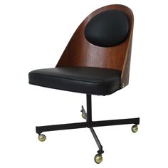 an office chair with wheels and a black seat pad on the back, against a white background