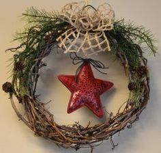 a red star is hanging on a wreath