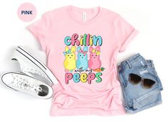 This cute Chillin with My Peeps Easter T Shirt is great for Easter day, spring or anytime you want to chill with your peeps! The design features three adorable easter bunny peeps with the words Chillin with My Peeps in pastel pink, yellow, blue and green. Purchase for yourself or anyone that loves peeps and Easter! This classic unisex jersey short sleeve tee fits like a well-loved favorite. Soft cotton and quality print make users fall in love with it over and over again. These t-shirts have-ribbed knit collars to bolster shaping. The shoulders have taping for better fit over time. Dual side seams hold the garment's shape for longer.  .: 100% Airlume combed and ringspun cotton (fiber content may vary for different colors) .: Light fabric (4.2 oz/yd² (142 g/m .: Retail fit .: Tear away labe Funny Pink T-shirt For Spring, Cute Spring Tops With Funny Text, Cute Spring Shirt With Funny Text, Cute Shirt With Funny Text For Spring, Cute Spring T-shirt With Funny Text, Funny Print Tops For Spring, Bunny Peeps, Chillin With My Peeps, Funny Easter Shirt