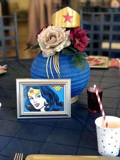 a blue vase with flowers and a picture on it