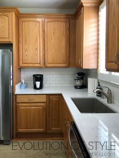 a kitchen with wooden cabinets and stainless steel appliances