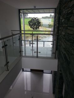 an empty room with glass railings and a large window