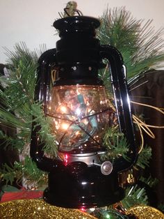 an old fashioned lantern with christmas lights in it