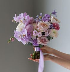 a person holding a bouquet of flowers in their hand