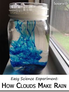 a glass jar filled with blue liquid sitting on top of a window sill