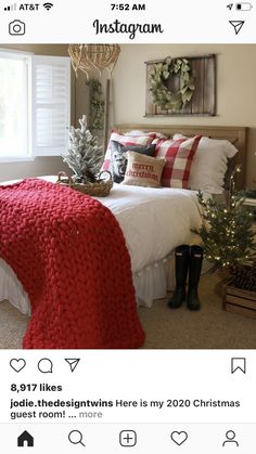 a bedroom decorated for christmas with red and white blankets on the bed, plaid throw pillows