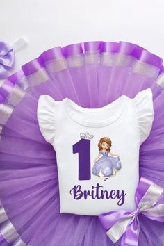 Your Princess will love this fabulous Sofia The First tutu outfit and you will give her a wonderful holiday! Bodysuit or T-shirt has a elegant princess Sofia print with any number of age. Every girl's the greatest wish is to look amazing! An adorable personalized outfit with a favorite character is always a good idea! Whenever it is a thematic party, birthday or even pleasure trip with family- be sure you sweetheart will always look awesome! Birthday Princess Dress With Ruffles And Short Sleeves, Birthday Ruffled Princess Dress With Short Sleeves, White Short Sleeve Princess Dress For Birthday, Cute Short Sleeve Princess Dress For Birthday, Princess Birthday Dress With Short Sleeves, Princess Dress With Short Sleeves For Birthday, Short Sleeve Princess Dress For Birthday, Princess Style Birthday Dress With Short Sleeves, Cute Short Sleeve Tutu Party Dress