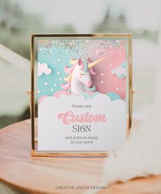 a card with a unicorn on it sitting on top of a wooden table