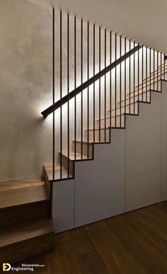 an image of a stair case with lights on the side and wood floors in front