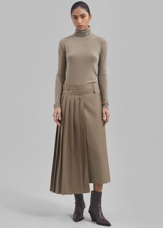 Color: Beige Lightweight woven fabric Regular fit Midi length Detachable partial pleated skirt with buckle closure A-line silhouette Asymmetrical hem Belt loops Side seam zip closure Unlined 80% Polyester 20% Rayon Dry Clean Imported Belted Fitted Pleated Skirt, Fitted Belted Pleated Skirt, Fitted Beige Bottoms With Accordion Pleats, Asymmetrical Pleated Skirt For Office, Office Wear Asymmetrical Pleated Skirt, Office Fitted Asymmetrical Pleated Skirt, Asymmetrical Pleated Office Skirt, Fall Pleated Asymmetrical Skirt, Asymmetrical Pleated Waist Skirt