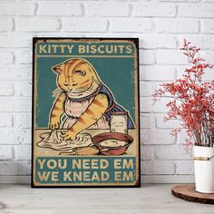 a yellow cat is sitting in front of a sign that says kitty biscuits you need em we knead em