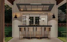 an outdoor kitchen with three stools and a bar in the middle of the room