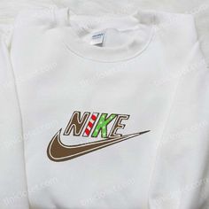 Cookie Christmas x Nike Embroidered Tshirt, Nike Inspired Embroidered Shirt, Best Christmas Gift Ideas Welcome to Tinicloset, the ultimate destination for all your custom embroidered apparel needs! Step into our wonderland of creativity, where fashion meets festive charm. At Tinicloset, we take pride in offering a diverse and delightful collection of custom embroidered shirts, sweatshirts, t-shirts, and hoodies that will elevate your style and spread the joy of the holiday season. One of our sta White T-shirt With Letter Embroidery For Gift, White T-shirt With Letter Embroidery As Gift, Christmas White Embroidered Tops, White Tops With Custom Embroidery For Christmas, White T-shirt With Embroidered Text For Winter, White T-shirt With Machine Embroidery For Gift, White T-shirt With Machine Embroidery As Gift, White Top With Embroidered Logo For Christmas, White Tops With Embroidered Logo For Christmas