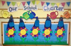 a bulletin board decorated with flowers and watering cans