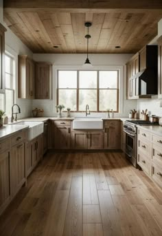 a large kitchen with wooden floors and white counter tops, wood paneling on the ceiling