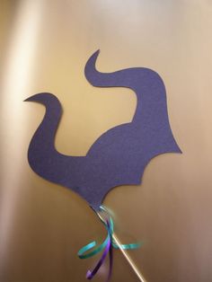 a purple bird cut out on top of a table