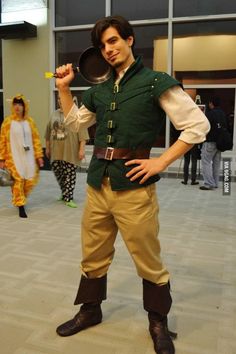 a man dressed up as peter pan and holding a frying pan in his hand