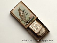 an old match box with a bird on it and some writing inside the card holder