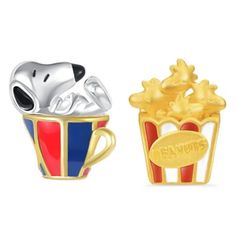 two charms in the shape of popcorn and a dog sitting on top of each other