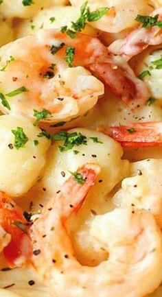 closeup of shrimp and pasta with parsley on top