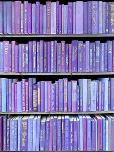 rows of purple books on shelves in a library