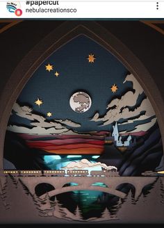 an arch with paper cut out of it and the moon in the sky over water