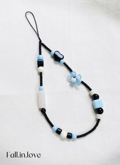 a black and white necklace with blue beads