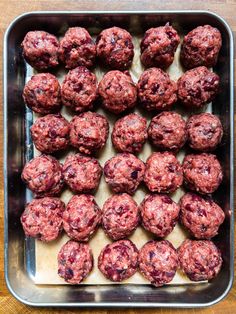 raw meatballs on a baking sheet ready to be cooked in the oven for dinner