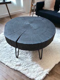 a coffee table made out of wood with hairpin legs on a rug in a living room