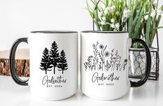 two personalized coffee mugs sitting next to each other on a white counter top