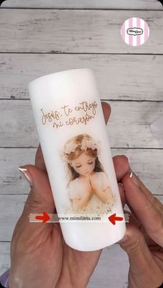 a hand holding a white tube with a picture on it