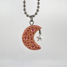 This clay moon pendant features red mica powder on tan clay and a silver star charm. A cord necklace will be included. This moon measures approximately 1"h and is lightweight! Our figurines and trinkets are all hand sculpted polymer clay. Each sculpture is unique and no two will be exactly alike. Remember while clay is quite durable it can be fragile and our figurines are not meant to be used as toys, handle them with love and care. If cleaning is needed a damp cloth can be used to wipe it off.  *Please note these sculptures are handmade, you may see fingerprints or other unique marks on the surface. Please contact us if you have any issue with your product, we want you to be happy with your purchase. Clay Star Necklace, Handmade Red Clay Jewelry, Polymer Clay Moon, Clay Mushroom Pendant, Polymer Clay Moon Pendant, Clay Moon, Clay Pendants, Mica Powder, Polymer Clay Pendant