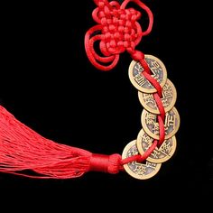 a red string with coins attached to it