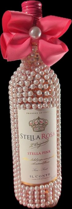 a bottle with pearls and a pink bow on it's top that says stella roa