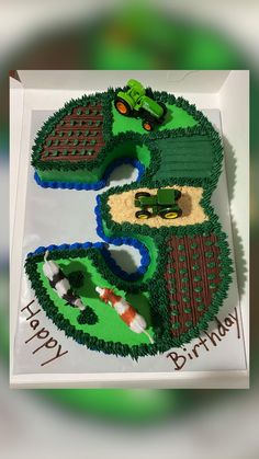 a birthday cake made to look like a tractor and farm scene