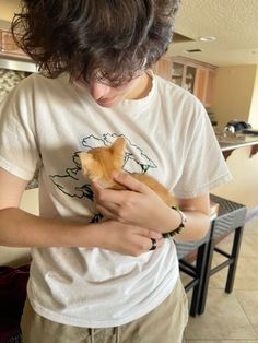 a person holding a cat in their hands