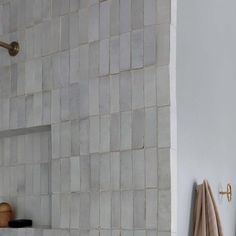 a bathroom with white tiles on the wall