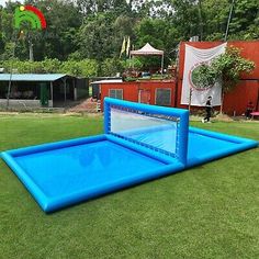 an inflatable pool on the grass near some trees