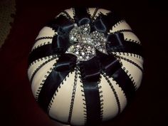 a white and black ball with a bow on it