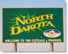 a green sign that says north dakota welcome to the cootaus and prairies