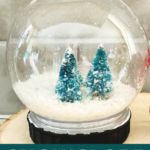 there is a snow globe with trees in it